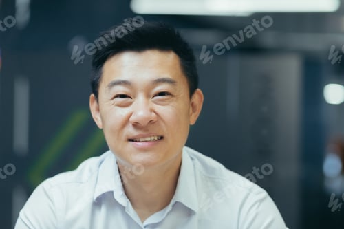 Preview: Close-up photo. Portrait of young handsome smiling Asian businessman i