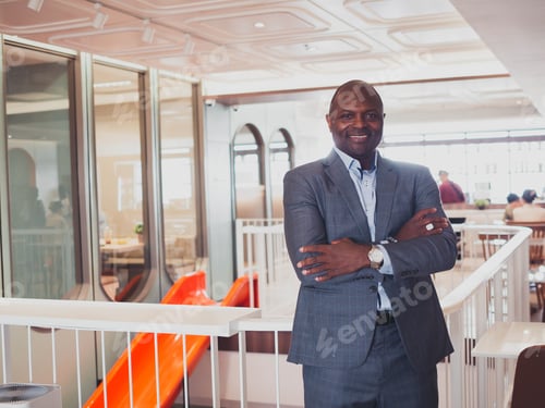 Preview: Businessman male smart handsome south africa look at camera arm cross person happy success business
