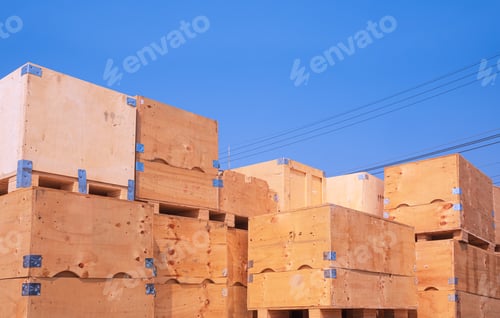 Preview: Pile of many the old big wooden box containers for sale and reusable against blue sky background