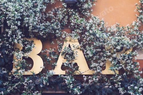 Preview: bar signage on a wall covered in flowers