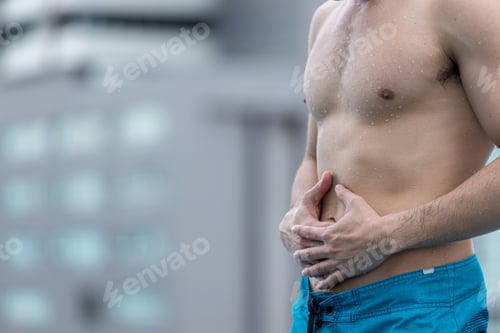 Preview: Man hold hands in painful areas which may be caused by gastritis, abdominal pain. Hands man holding