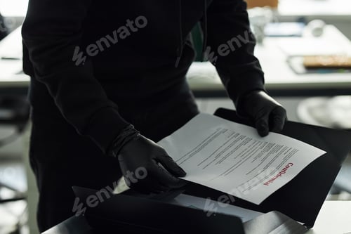 Preview: Unrecognizable Man in Black Clothes and Gloves Handling Confidential Documents