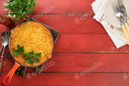 Preview: Shepherd's Pie with ground beef, peas, carrots, onions, potato and cheese on old wooden background i