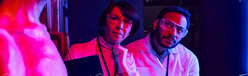 Preview: multiethnic scientists looking at humanoid alien in innovation hub, futuristic concept, banner