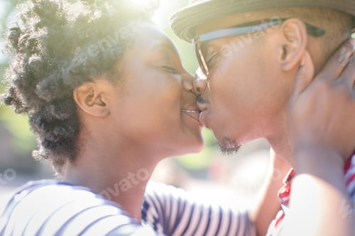 Preview: Close up of young couple kissing in park
