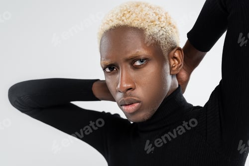 Preview: portrait of young african american man with different eye colors isolated on grey