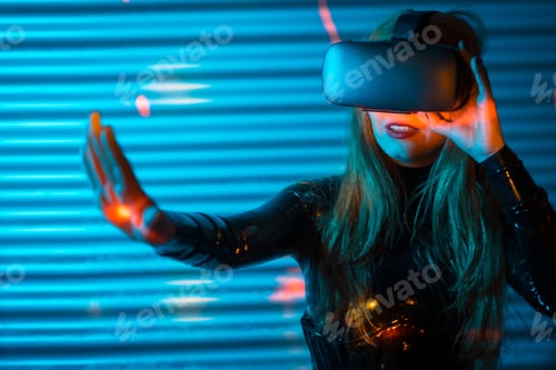 Preview: Blonde woman playing using virtual reality goggles