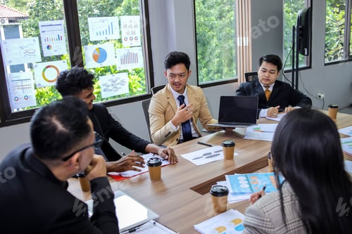 Preview: Young male employee discussing online project, showing computer presentation to skilled team leader