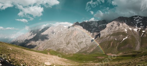 Preview: Cloudy peak from Turkish mountains with rainbow.