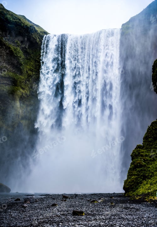 Preview: Vertical shot of a beautiful waterfall flowing in the forest