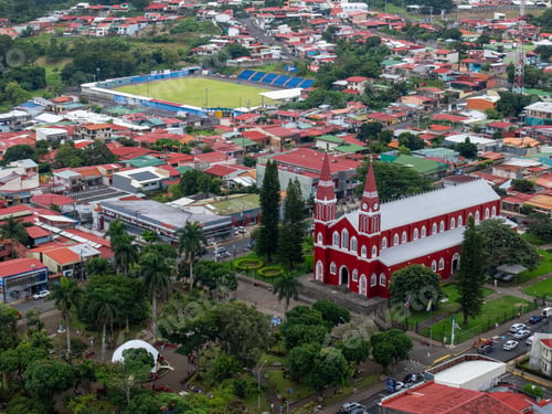 Preview: Aerial view of Grecia, Costa Rica with greenery and the red church, Temple of Our Lady of Mercy