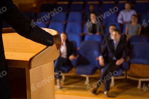 Preview: Mid section of male business executive giving a speech