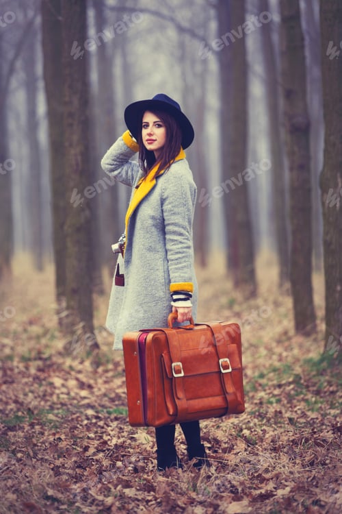 Preview: portrait of a young woman with a suitcase