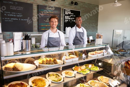 Preview: Male Staff Working Behind Counter In Delicatessen