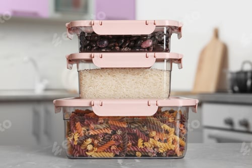 Preview: Stacked boxes with different food on table in kitchen