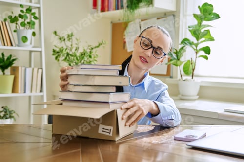 Preview: Woman with new books unpacked from cardboard box