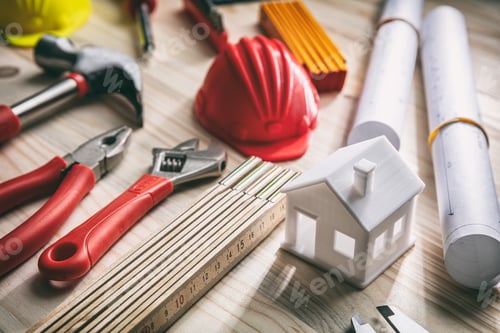 Preview: Tools, hardhats and project plans on wooden desk