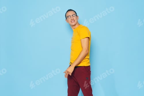 Preview: man in yellow t-shirt emotions studio blue background