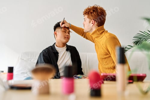 Preview: Gay couple applying make up at home