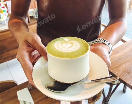 Preview: Barista holding matcha latte