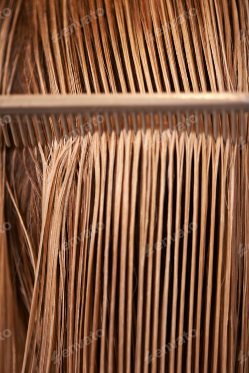 Preview: This is what healthy hair looks like. A view of a comb running through long blonde hair.