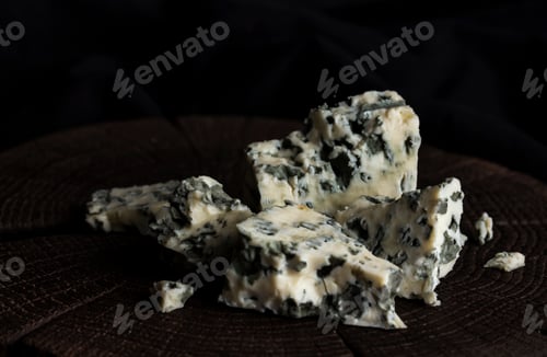Preview: Danish blue cheese on black wooden background, with copy space