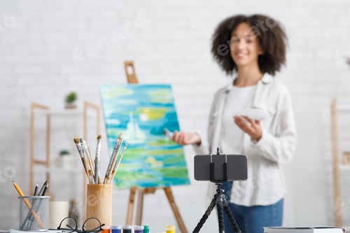 Preview: Smartphone, glasses and paint brushes. Focus on gadget and tools for art lesson