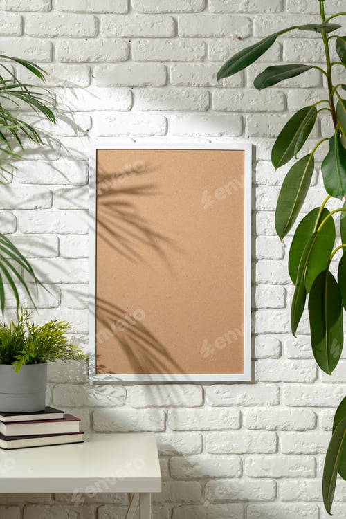 Preview: Shadow of Palm Leaves Cast on Framed Picture Against White Brick Wall