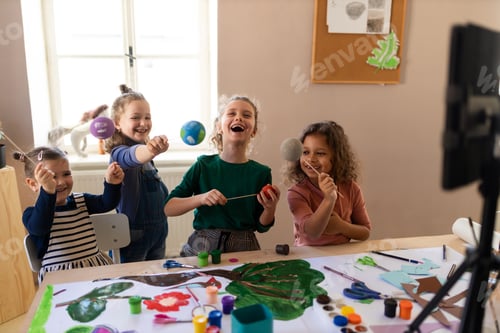 Preview: Little kids working on project during creative art and craft class at school.