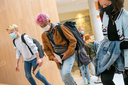 Preview: Mixed race teenage students walking through the school to their next class