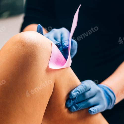 Preview: Waxing - Beautician Removing Unwanted Hair from Female Leg with Wax Strips