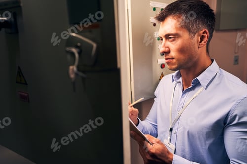 Preview: Male engineer concentrated on monitoring operation of equipment