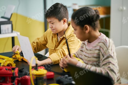 Preview: Children Engaging in Science Experiment in Classroom