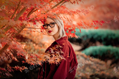 Preview: Beautiful girl in red shirt in a park