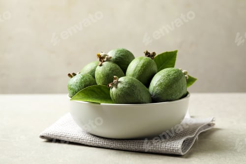 Preview: Delicious fresh feijoas in bowl on light grey table