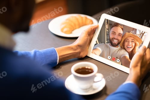 Preview: African Man Using Digital Tablet Calling Friends Sitting In Cafe