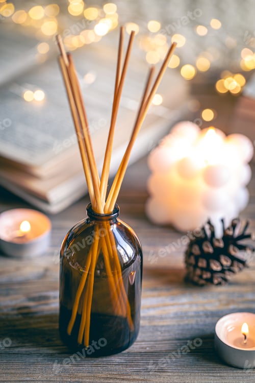 Preview: Winter spa composition with incense sticks, candles and bokeh lights.