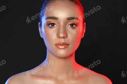 Preview: Beautiful young woman with glitter makeup on black background
