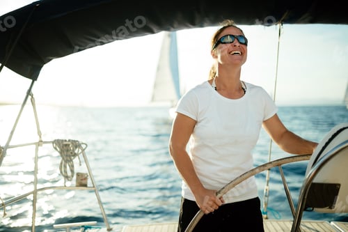 Preview: Attractive strong woman sailing with her boat