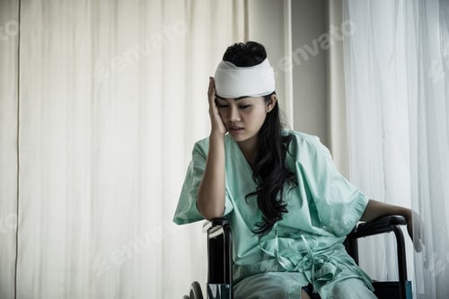 Preview: Female patients having pain in her head after hospitalization in patient's room hospital.