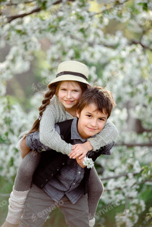 Preview: A boy and a girl are having fun while trees are blooming