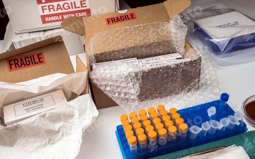 Preview: Boxes with Covid-19 PCR kit in hospital warehouse, conceptual image