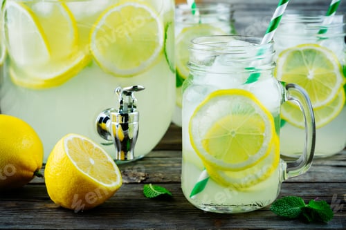Preview: Homemade lemonade with mint, ice, and fresh lemon slices in mason jar