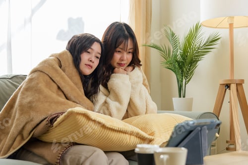 Preview: Winter day brings women friends comforting moments at home, warm friendship evident watching screen