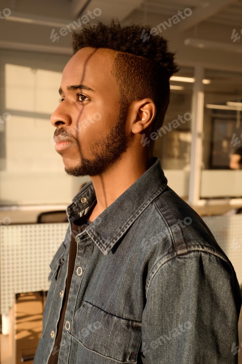 Preview: Young Black Man Working at Sunset in Office