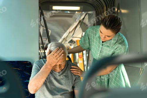Preview: Young woman and senior man is feeling sick with migraine symptoms in public transport