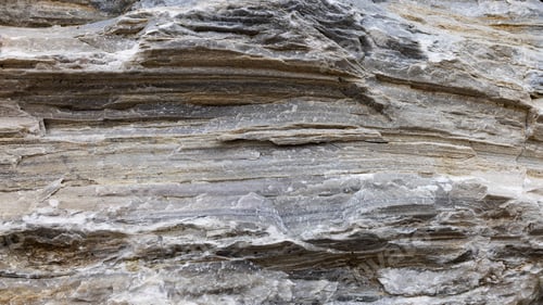 Preview: Layered natural stone in Alps with deep cracks. Filled frame 16x9 background screensaver for webinar