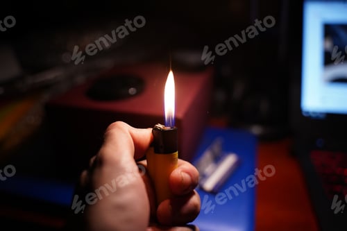 Preview: Male hand lighting a cigarette lighter