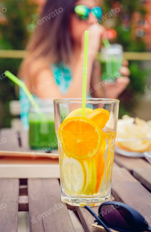 Preview: Infused fruit water cocktails and woman drinking green smoothie