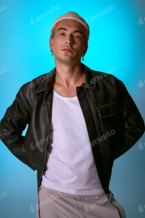 Preview: Stylish young man with a confident pose against a vibrant blue background